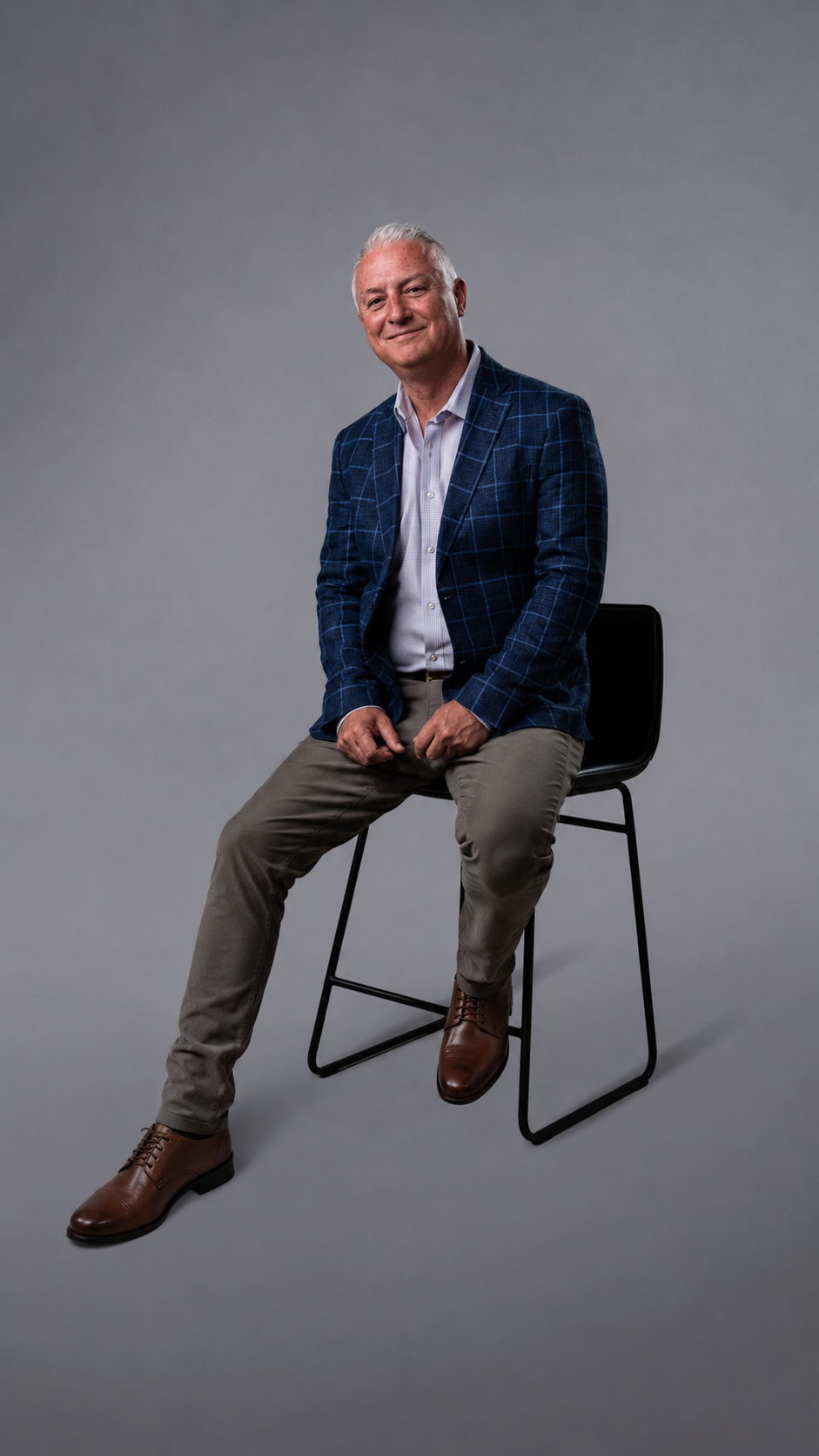 Bryan Benson seated in a studio portrait.