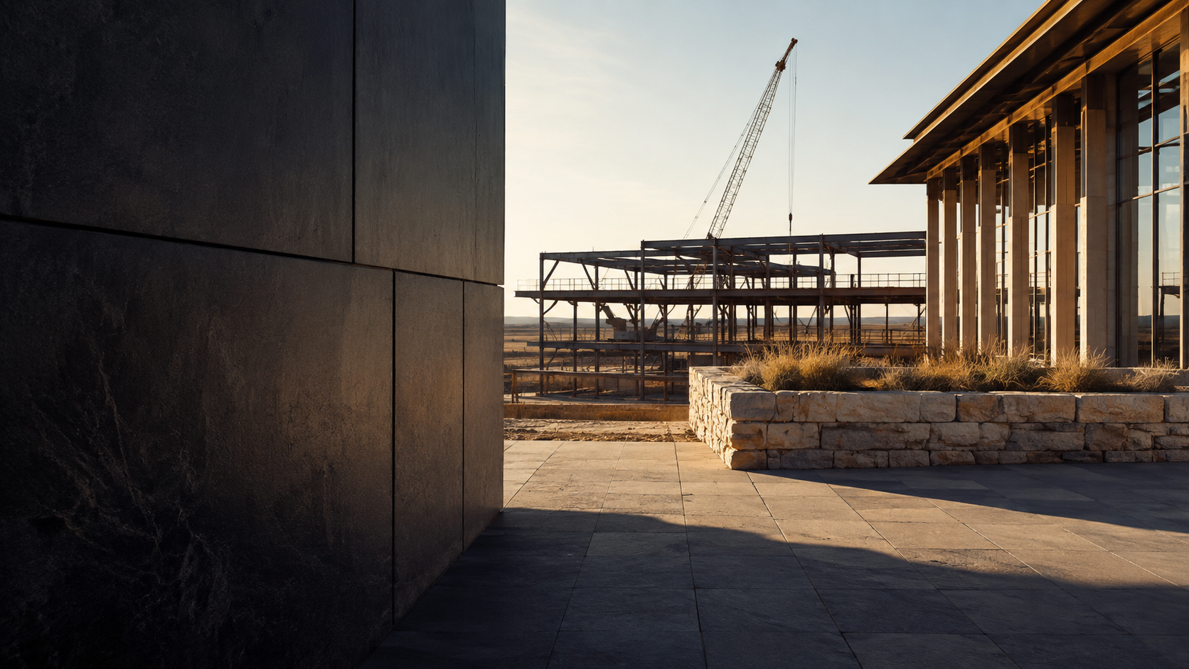 Architectural development site with stone, steel, and warm West Texas light.